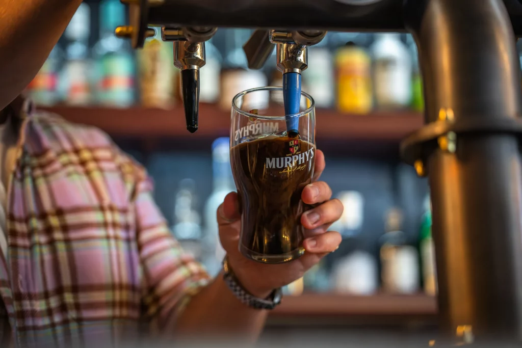 A pint of Murphy's stout being poured from the tap at the bar.