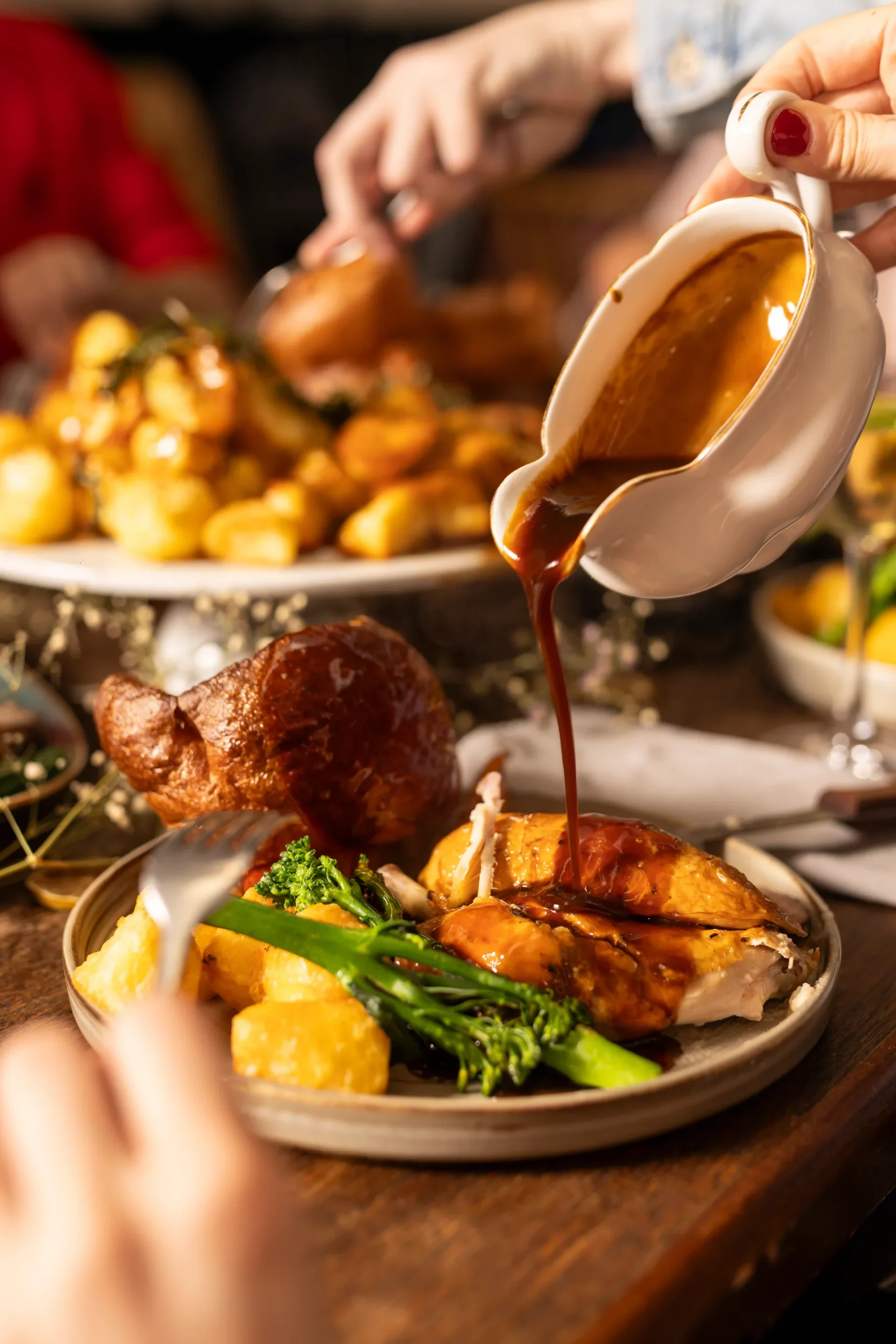 Roast corn-fed chicken breast with crisp golden skin and gravy poured over from a gravy boat, served with roast potatoes, tenderstem broccoli and a Yorkshire pudding at The Hill in Streatham Hill.